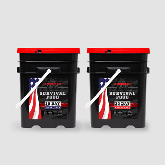 Two 30 Day Emergency Food Supply black buckets by American Reserves, featuring red lids and a U.S. flag design, offer peace of mind with their remarkable 25-year shelf life thanks to freeze-dried preservation.