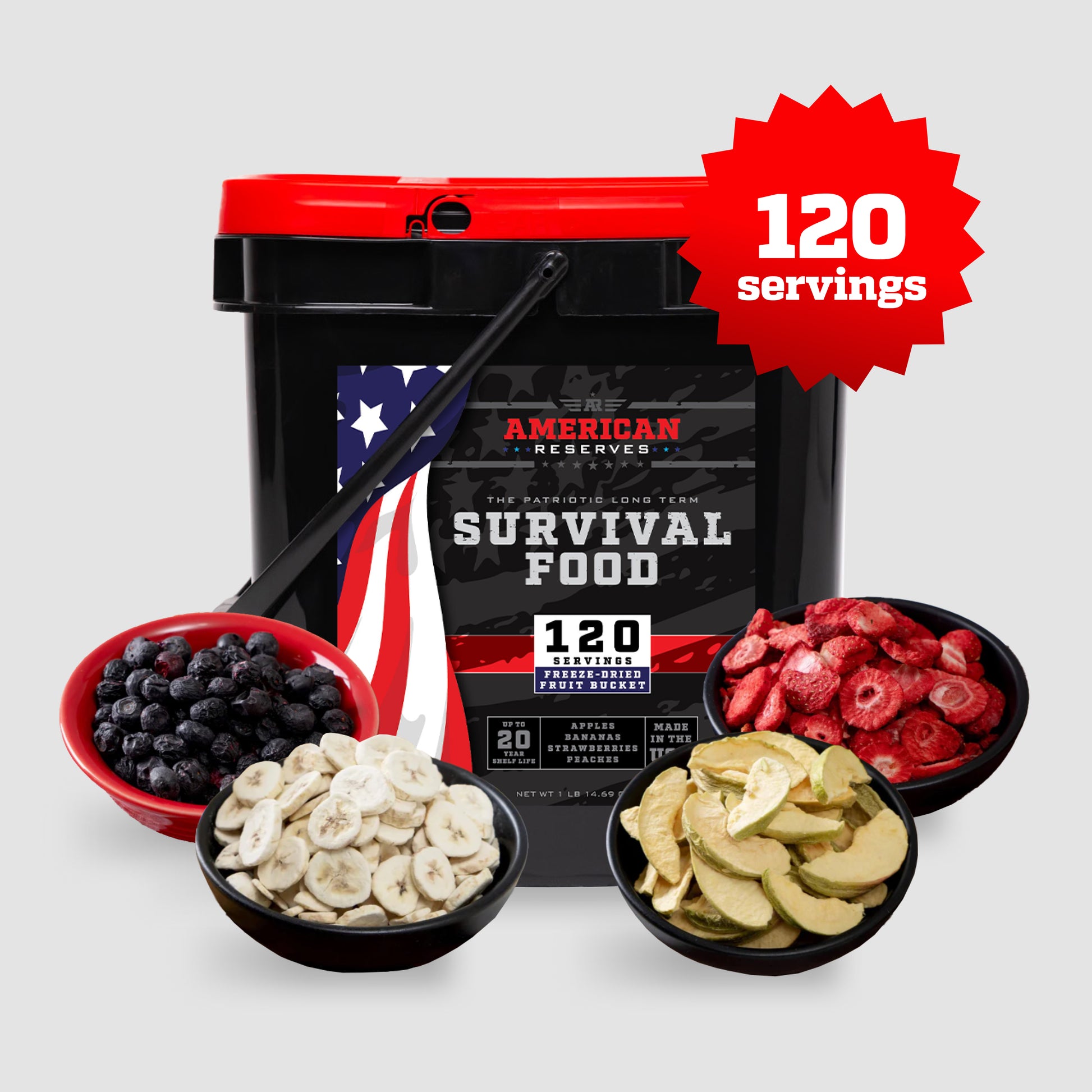 The 120 Serving Freeze Dried Fruit Bucket by American Reserves features a black and red design with an American flag theme, highlighting its long shelf life. The foreground showcases bowls of freeze-dried blueberries, strawberries, bananas, and apples.