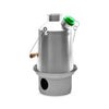 The Kelly Kettle® Ultimate Scout Kit by American Reserves features a stainless steel camp kettle with a green cap and handle, complete with a circular base that includes a round cutout.