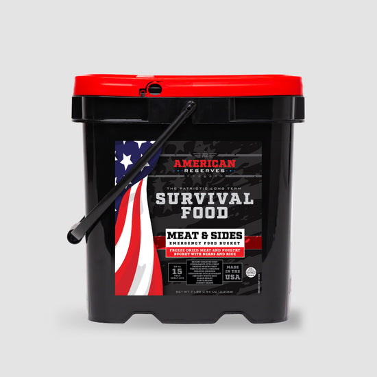 The 110 Serving Freeze Dried Meat & Sides Bucket by American Reserves features a black and red design with an American flag. This Survival Food product offers a 15-year shelf life and is proudly made in the USA.