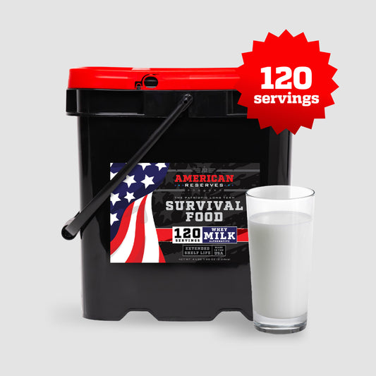 A black bucket labeled American Reserves 120 Servings Emergency Whey Milk Alternative features a red lid and American flag design, highlighting a 25-year shelf life. Its displayed beside a full glass of milk on a light gray background as a long-term solution.