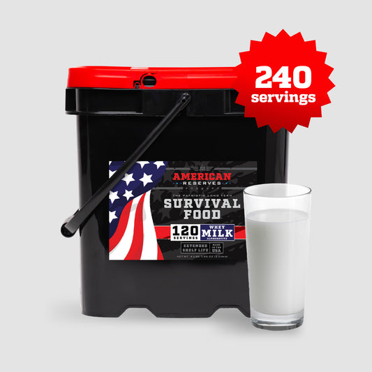 A black and red bucket labeled American Reserves 240 Servings Milk Bundle with a glass of milk beside it features a starburst graphic in red and white heralding 240 servings. The label, adorned with an American flag design, promotes long-term storage and a 25-year shelf life.